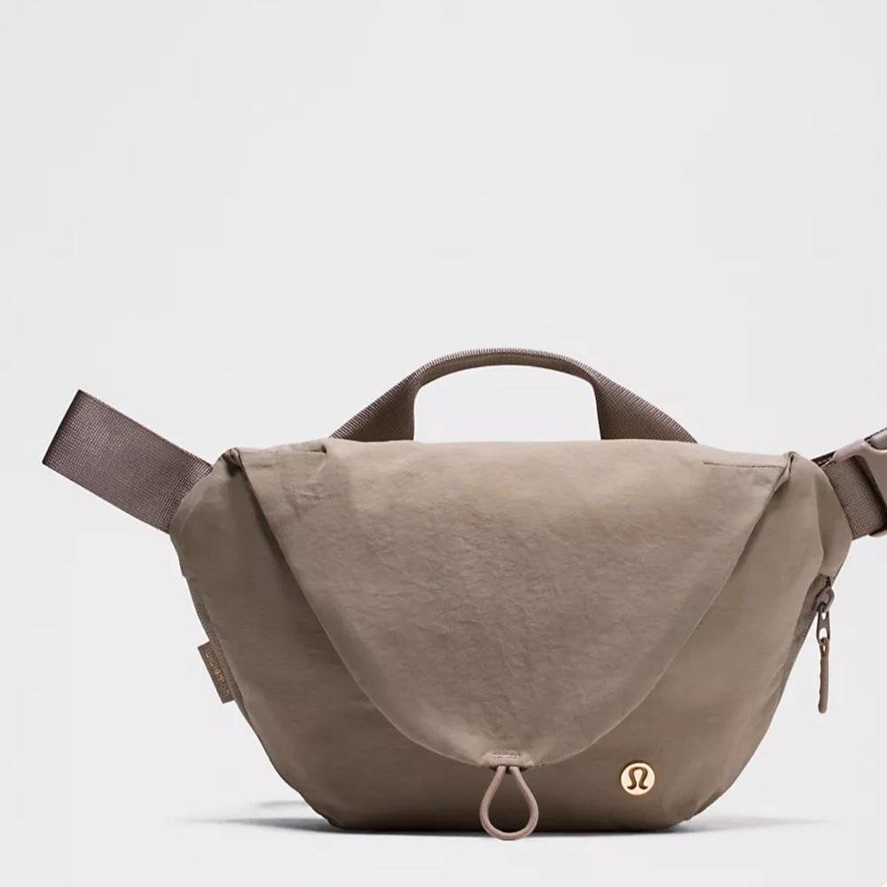 Lululemon curved crossbody bag 3L.  Warm Ash Grey Color